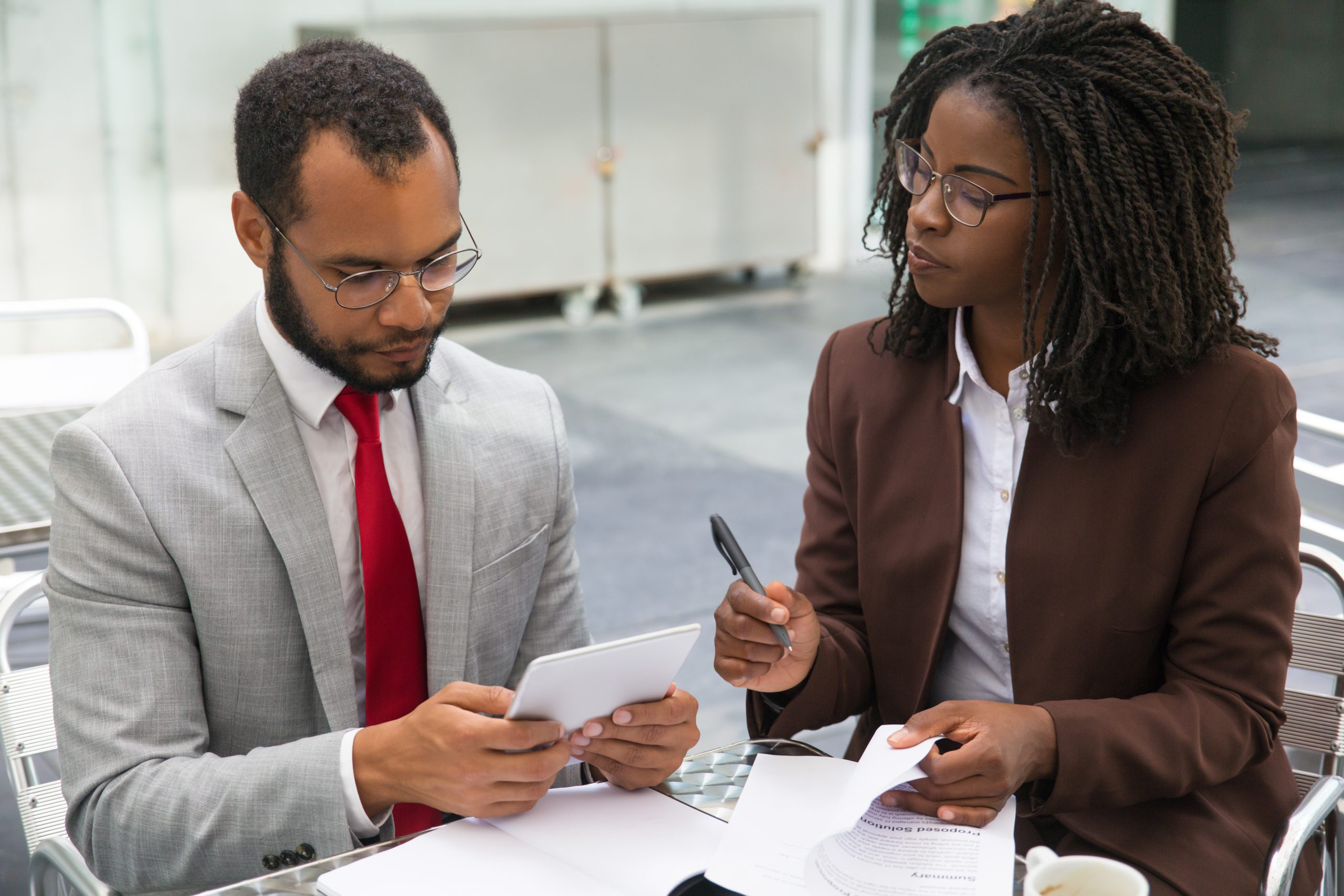 business colleagues studying reports scaled.jpg