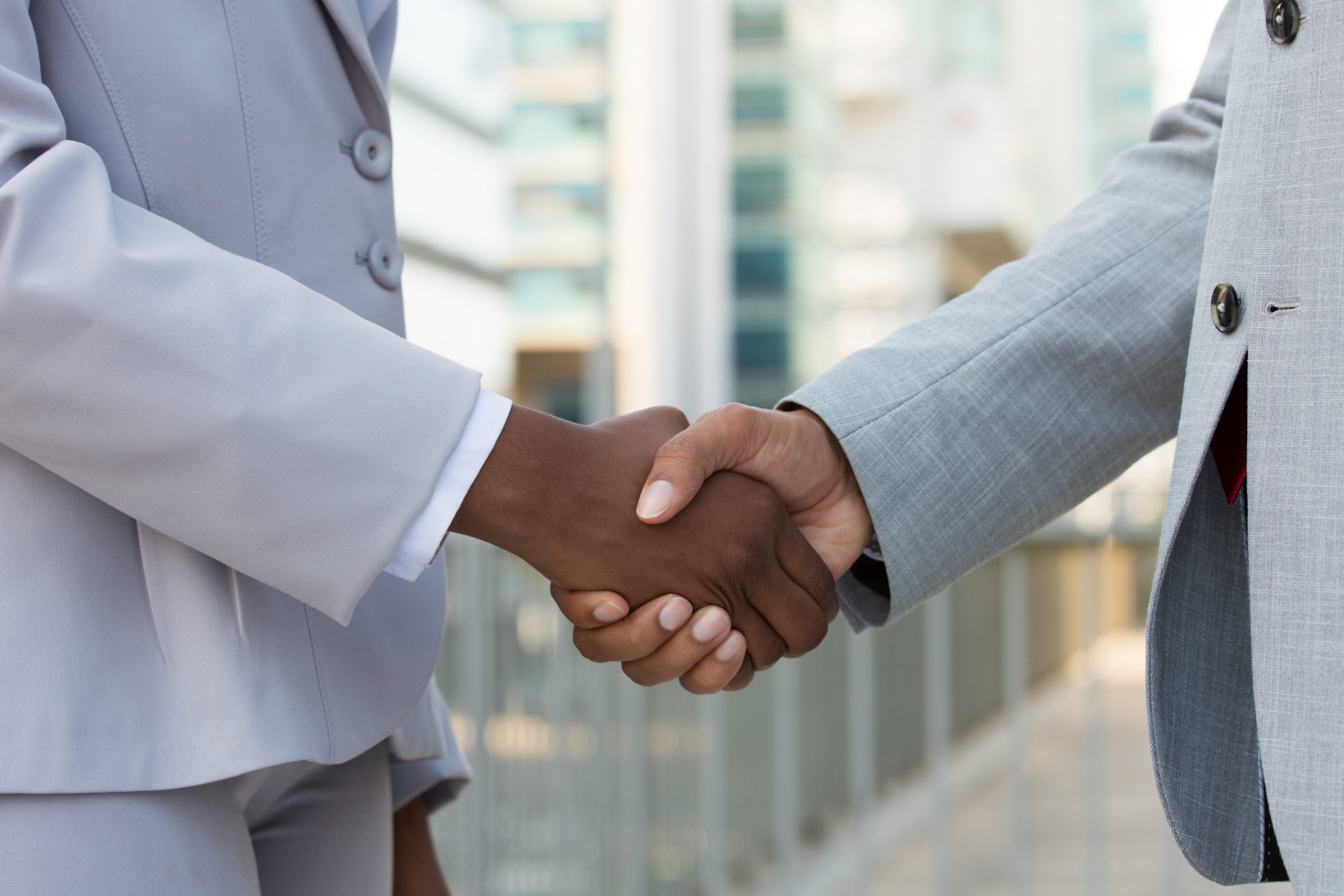 multiethnic leaders greeting each other city scaled.jpg